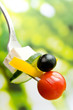 Cherry-tomato, cucumber, olive, pepper, cheese on a plug