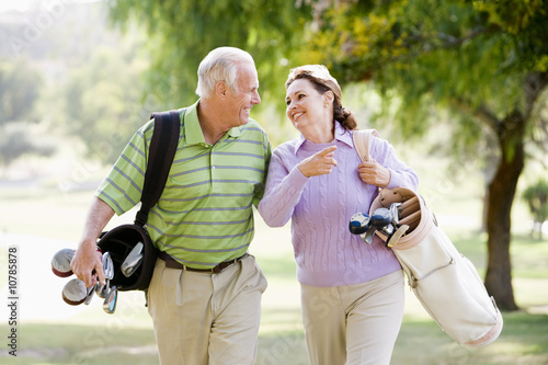 Photo: Couple Enjoying A Game Of Golf Couple Enjoying A Game Of Golf
