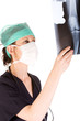 Young adult female doctor examining an x-ray