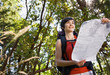 Woman with backpack looking at map