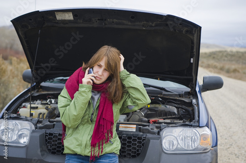 Photo: Teenage girl with a broken car Teenage girl with a broken car