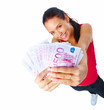 Cheerful young woman holding cash and smiling