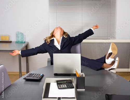 Photo: Beautiful woman relaxing in office Beautiful woman relaxing in office