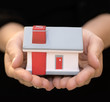 Hands holding house