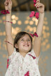 Smiling little girl playing with butterfly garland