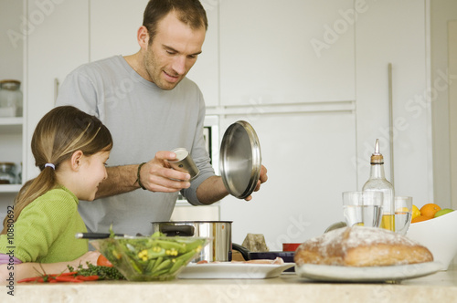 Photo: Man and little girl cooking Man and little girl cooking