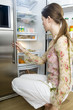 Woman looking into refrigerator
