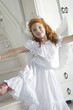 Little girl in an angel costume, looking at the camera, indoors