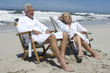 Couple in bathrobe, sitting on beach chairs