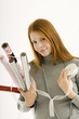 Portrait of a young woman holding rolls of wrapping papers