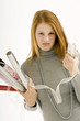 Portrait of a young woman holding rolls of wrapping papers