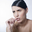 anxious woman biting her nails
