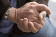 Man's hands clasped.