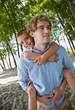 Father giving son piggy back ride