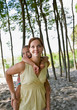 Mother giving daughter piggy back ride