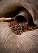 Cezve with freshly roasted coffee beans on sackcloth