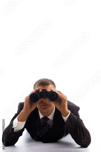 Photo: smart young lawyer using a pair of binoculars smart young lawyer using a pair of binoculars