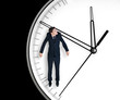 Businessman hangs on an arrow of clock Businessman hangs on an arrow of clock