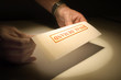 Final demand letter being read under a spotlight Final demand letter being read under a spotlight