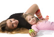 daughter lies on mum on the floor
