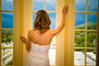 Bride standing in a window
