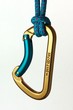 Blue and gold karabiner hanging from a rope
