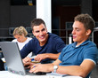 Young modern students using laptop