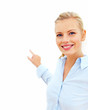 Smiling young business woman pointing towards open space