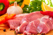 Fresh raw pork on board with fresh, vegetables
