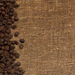 card with coffee beans on background from sacking