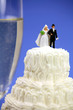 Photo: Bride and groom on top of a wedding cake.Marriage concept. Bride and groom on top of a wedding cake.Marriage concept.