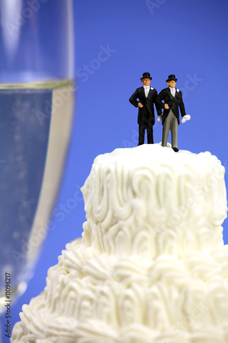 Photo: Homosexual couple on a wedding cake. Gay marriage concept. Homosexual couple on a wedding cake. Gay marriage concept.