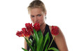 woman with tulips and revolver isolated on white background