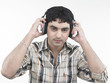 a handsome asian male of indian origin listening to music