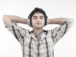 a handsome asian male of indian origin listening to music