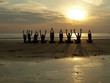 Yoga class at sunset by the ocean Yoga class at sunset by the ocean