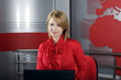 beautiful smiling TV Presenter in front of the laptop on the air beautiful smiling TV Presenter in front of the laptop on the air