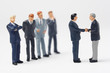 Foto: Two business figurines shaking hands Two business figurines shaking hands
