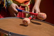Women playing the orange drum.