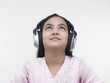 an asian teenage girl of indian origin listening to music