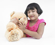 portrait of an asian girl with her brown teddy bear
