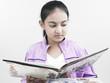 asian girl of indian origin reading a book
