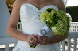 Torso of a bride holding her bouquet