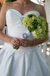 Torso of a bride holding her bouquet