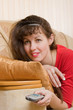 Young woman with a remote controle