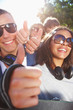 Photo: Happy young friends showing thumb's up sign Happy young friends showing thumb's up sign