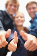 Happy men and woman showing thumbs up sign