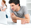 Portrait of smart young male using a laptop at home with girl at