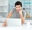 Portrait of a young smart male with a laptop