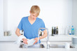 Young boy wiping the plate in the kitchen
